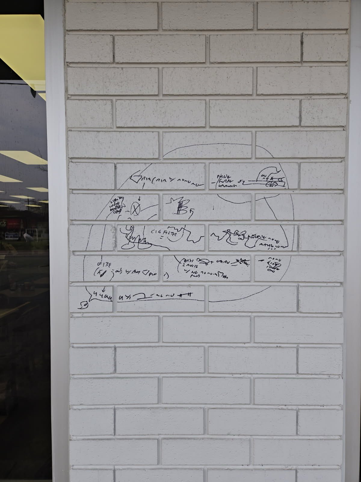 Clean light brick wall with graffiti marks removed, showing restored exterior surface