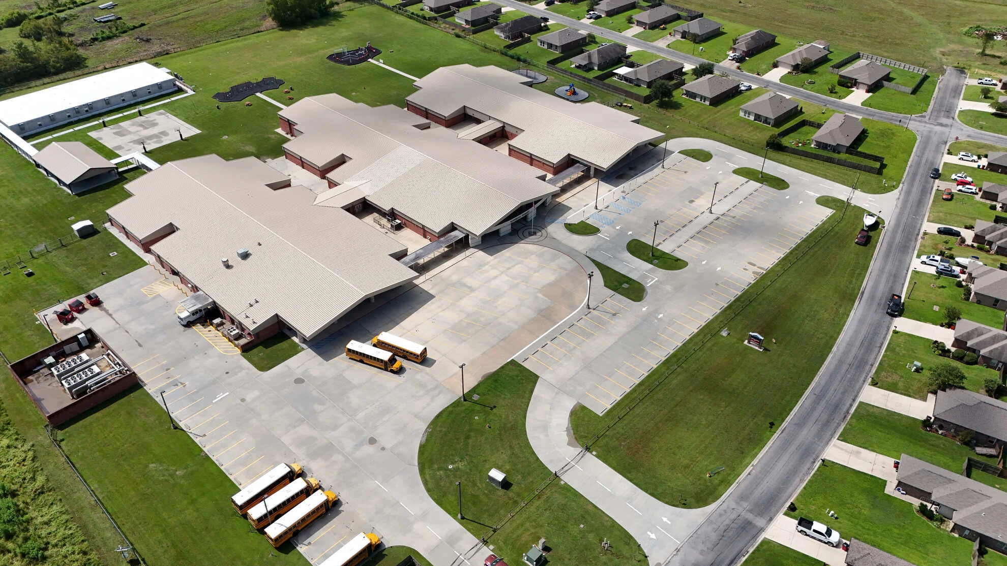 A commercial building exterior in Satsuma, Alabama shown after professional soft washing, with clean facade walls and a clear concrete walkway free of mold and algae staining. The building sits along a commercial corridor typical of Mobile County, reflecting the results of exterior washing service.